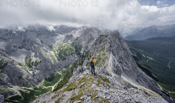 Mountaineer at the summit of the Waxenstein