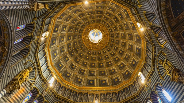 The dome of the cathedral with starry sky and black and white striped marble columns and round arches