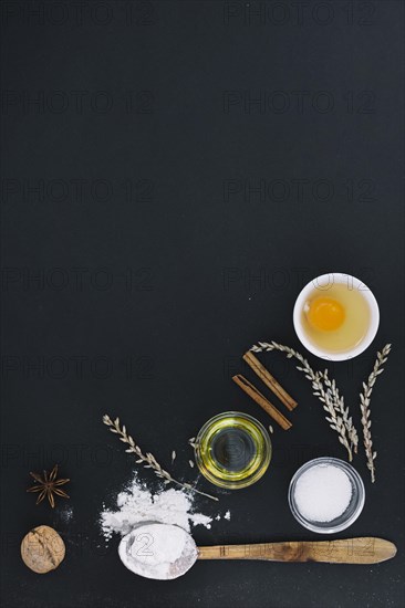 High angle view various baking ingredients black background