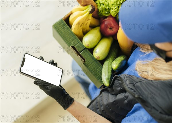 Close up woman holding food crate