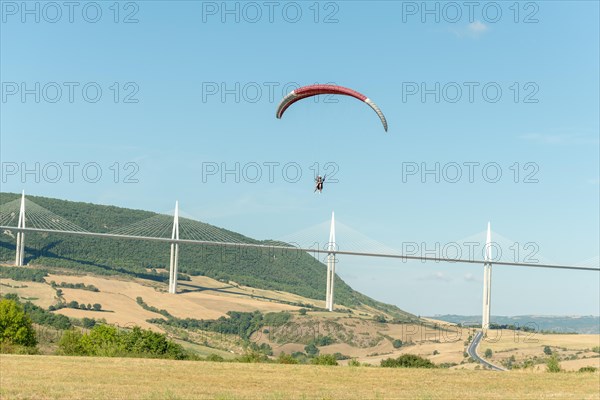 Paraglider in front of the Millau Bridge. Grands Causses