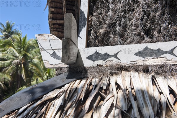 View of detail in form of fish traditional painting decoration on wooden beams of historic meeting house for men of indigenous tribe in South Pacific