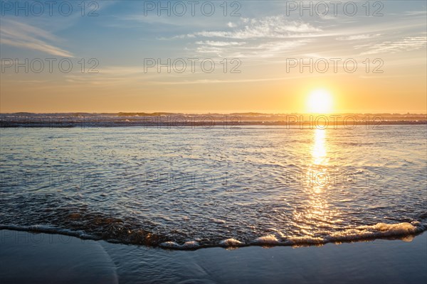 Atlantic ocean sunset with surging waves at Fonte da Telha beach