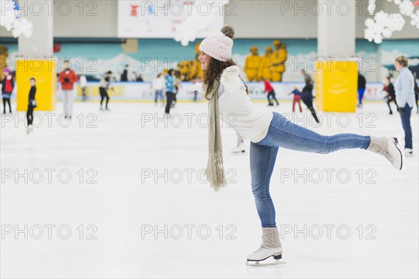 Side view woman skating one leg