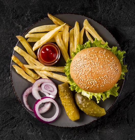 Top view burger fries plate with pickles