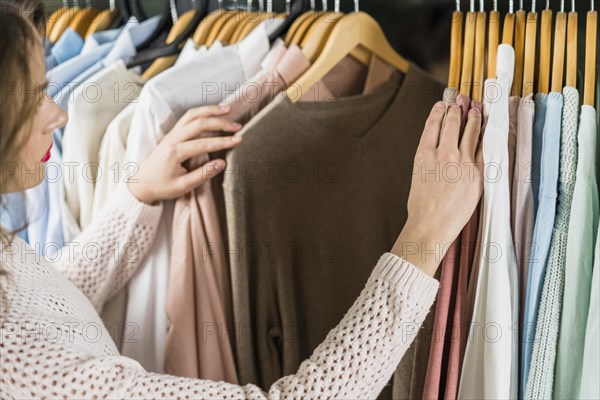 Woman choosing dress during shopping garments apparel