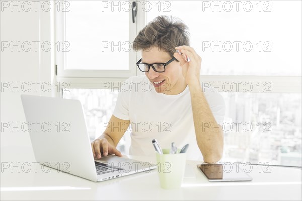 Happy man looking laptop screen