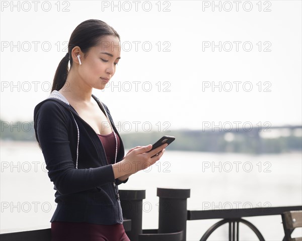 Beautiful young woman browsing mobile phone