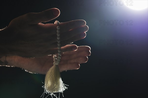 Person holding holy bracelet full moon