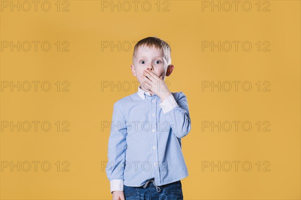 Astonished boy looking camera