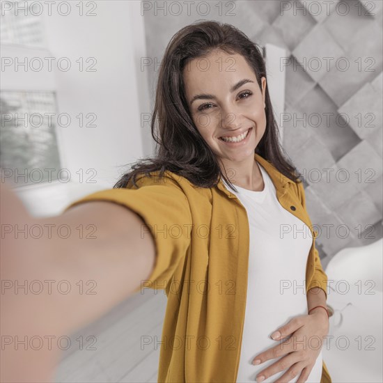 Pregnant woman taking selfie