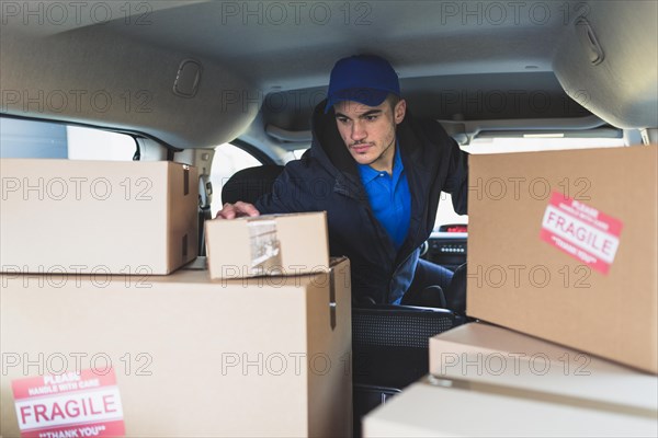 Man car checking boxes delivery