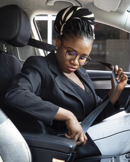 Side view woman putting seat belt drive