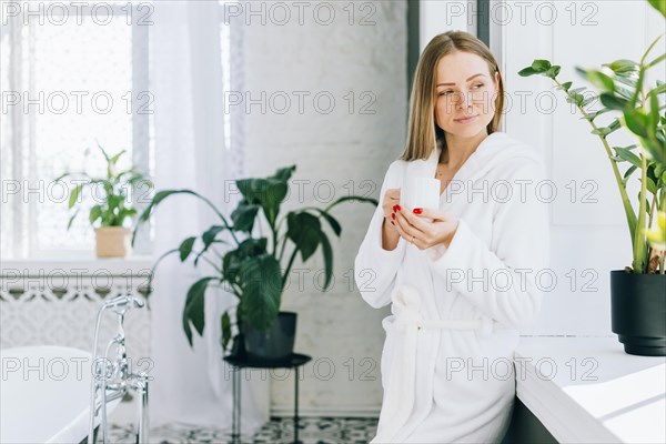 Girl having coffee bathroom