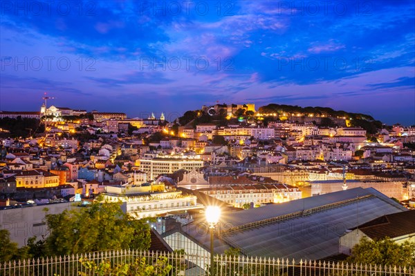 View of Lisbon famous view from Miradouro de Sao Pedro de Alcantara tourist viewpoint in the evening. Lisbon