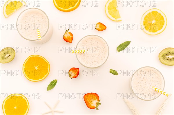 Milkshakes with straws cut fruits berries