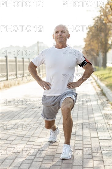 Elder man doing exercises outdoors