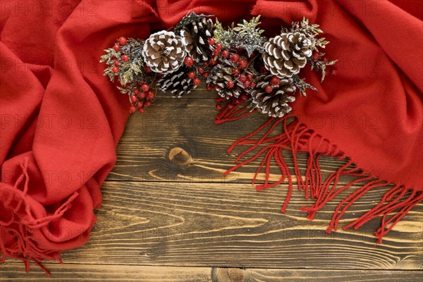 Flat lay cute winter pine cones red scarf