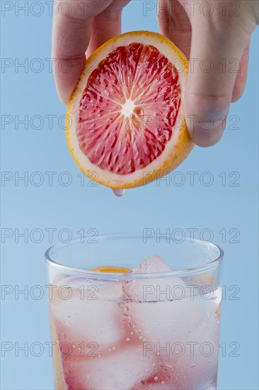 Close up man holding red orange slice