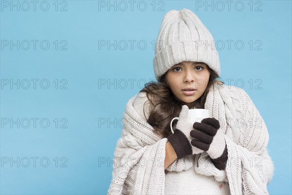 Little girl winter drinking hot tea copy space