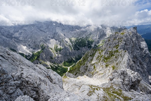 View from the summit of the Waxenstein over rocky and narrow ridge of the Waxenstein ridge to Hoellental and Jubilaeumsgrat