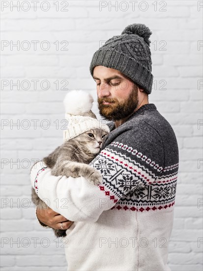 Front view man kitten wearing fur cap