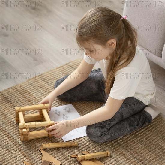 Full shot girl playing floor