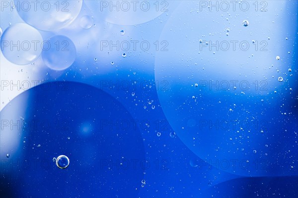 Faded oil drops water surface abstract background