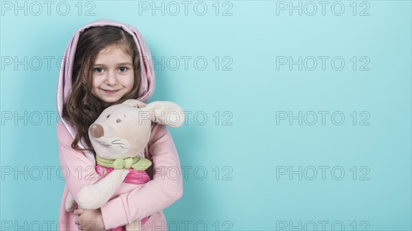 Little girl standing with toy bunny