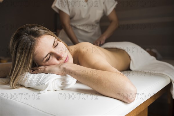Relaxed woman getting massage spa