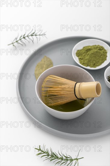 Close up matcha powder bamboo whisk