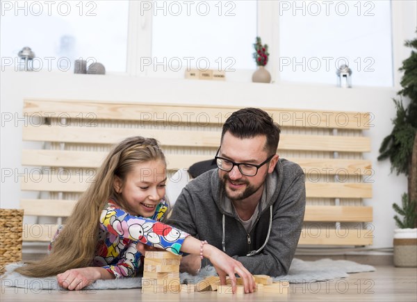 Father daughter playing with wood blocks