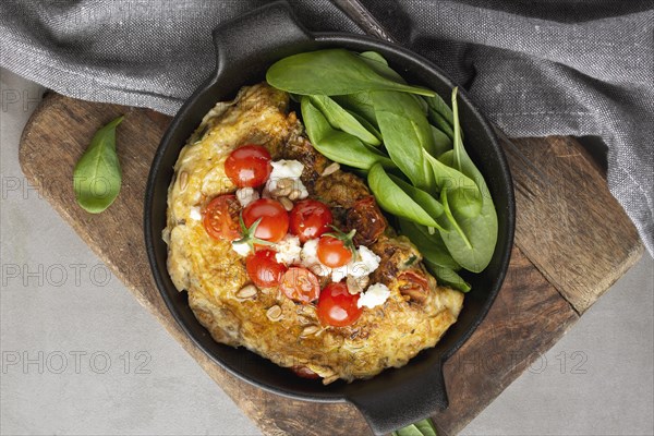 Omelette with cheese tomatoes cutting board
