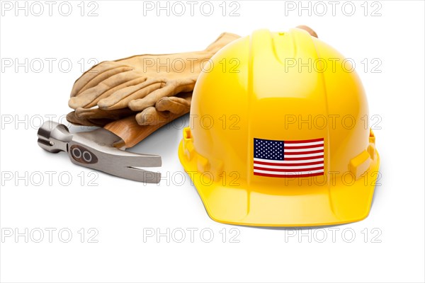 Yellow hardhat with an american flag decal on the front with hammer and gloves isolated on white background