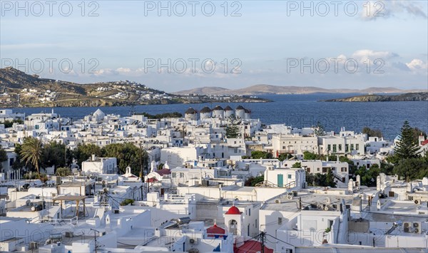 View over white Cycladic houses and windmills