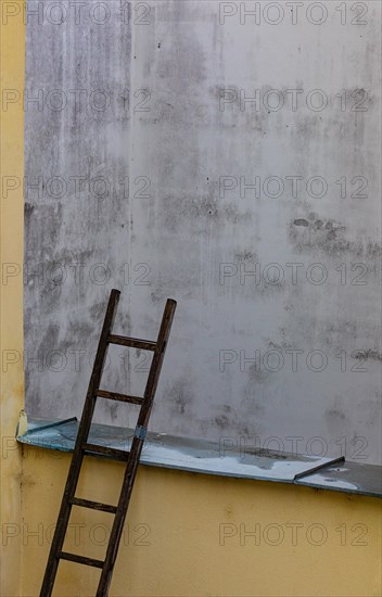 Stepladder leaning against a backyard facadein the historic old town of Ceske Budejovice