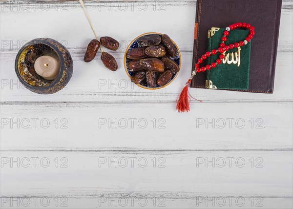 Juicy dried dates bowl candle diary kuran islamic rosary prayer beads white wooden desk