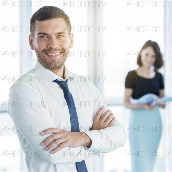 Portrait happy businessman with folded arms
