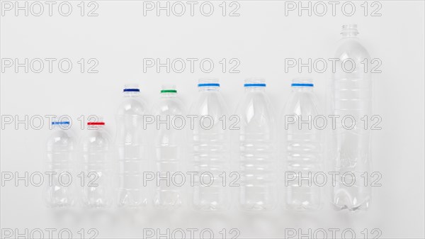 Various types plastic bottles grey background