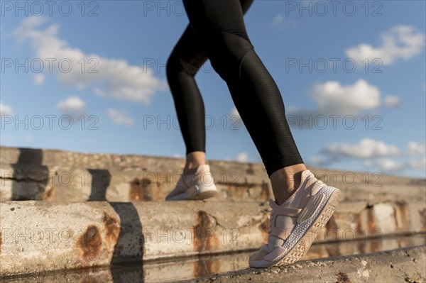 Woman jogging stairs close up