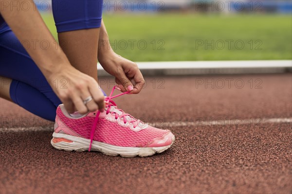 Close up woman bind shoes laces