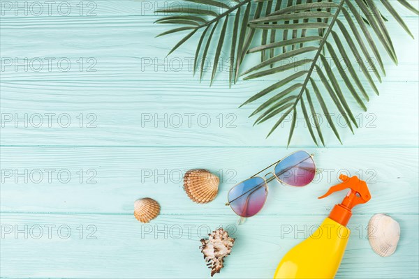 Tropical leaves with beach accessories composition