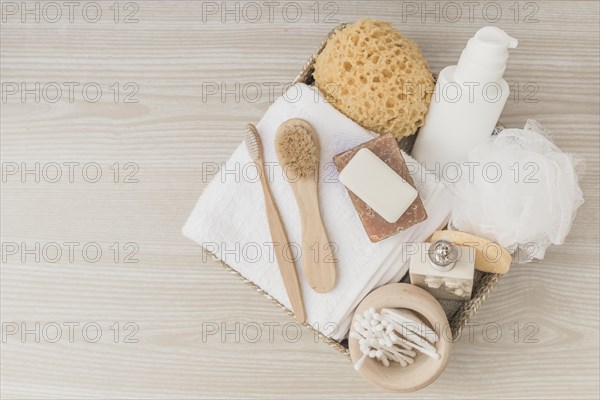 Elevated view spa products with brushes loofah tray wooden surface