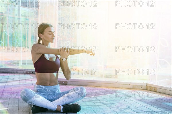 Healthy young woman sportswear stretching her hand during exercise bridge