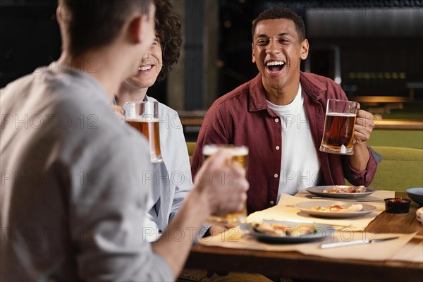 Close up happy men with beer mugs