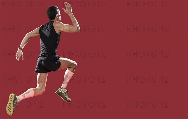 Low angle man running with copy space