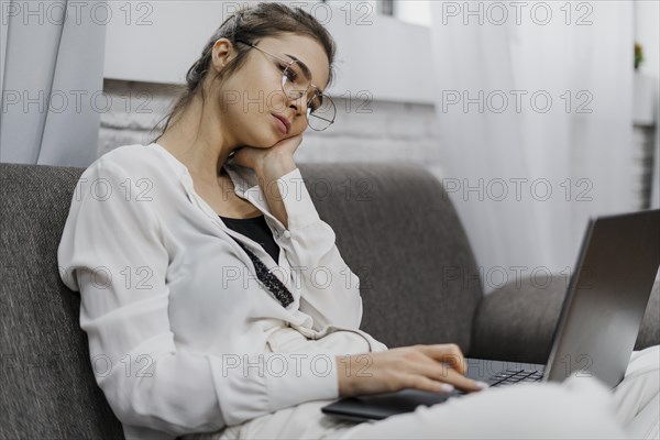 Woman looking bored while working