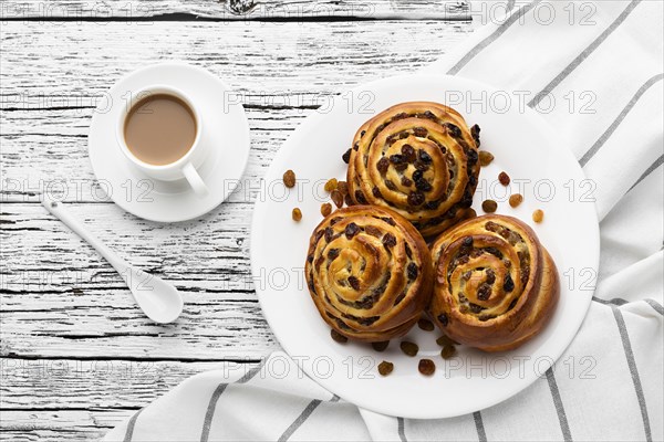 Delicious cinnamon raisins rolls wooden table