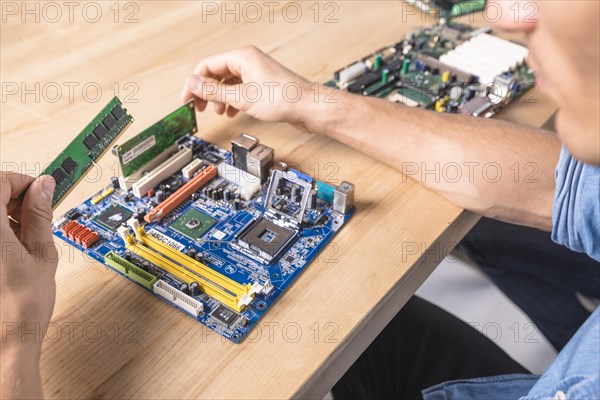 Engineer putting ram memory module motherboard