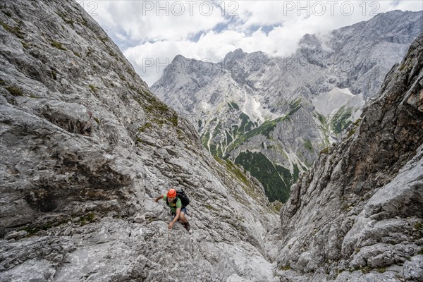 Mountaineer climbing in steep rocky terrain on the way to Waxenstein